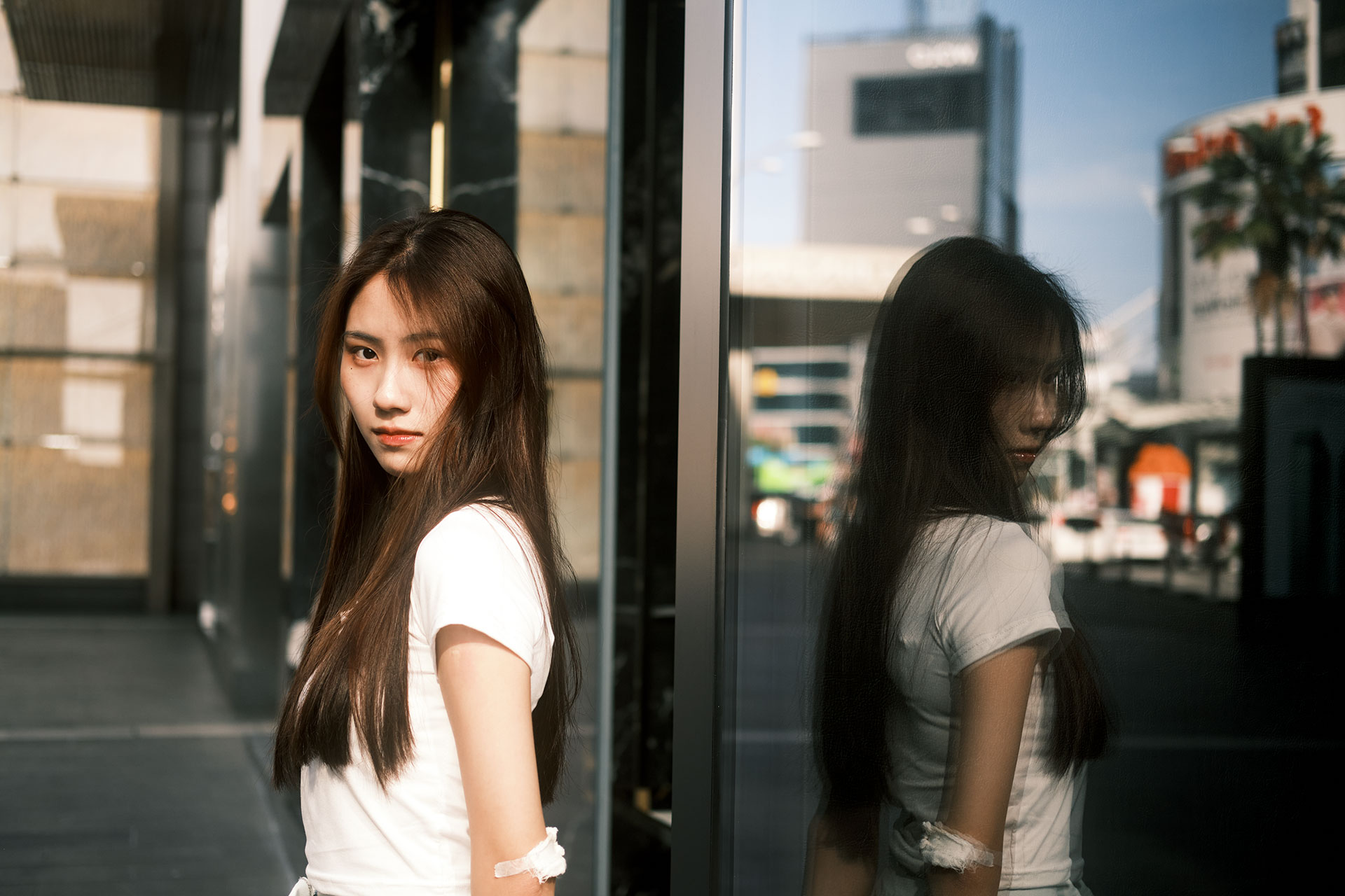 Portrait Photography Lenses - An Asian girl portrait with reflection on the glass